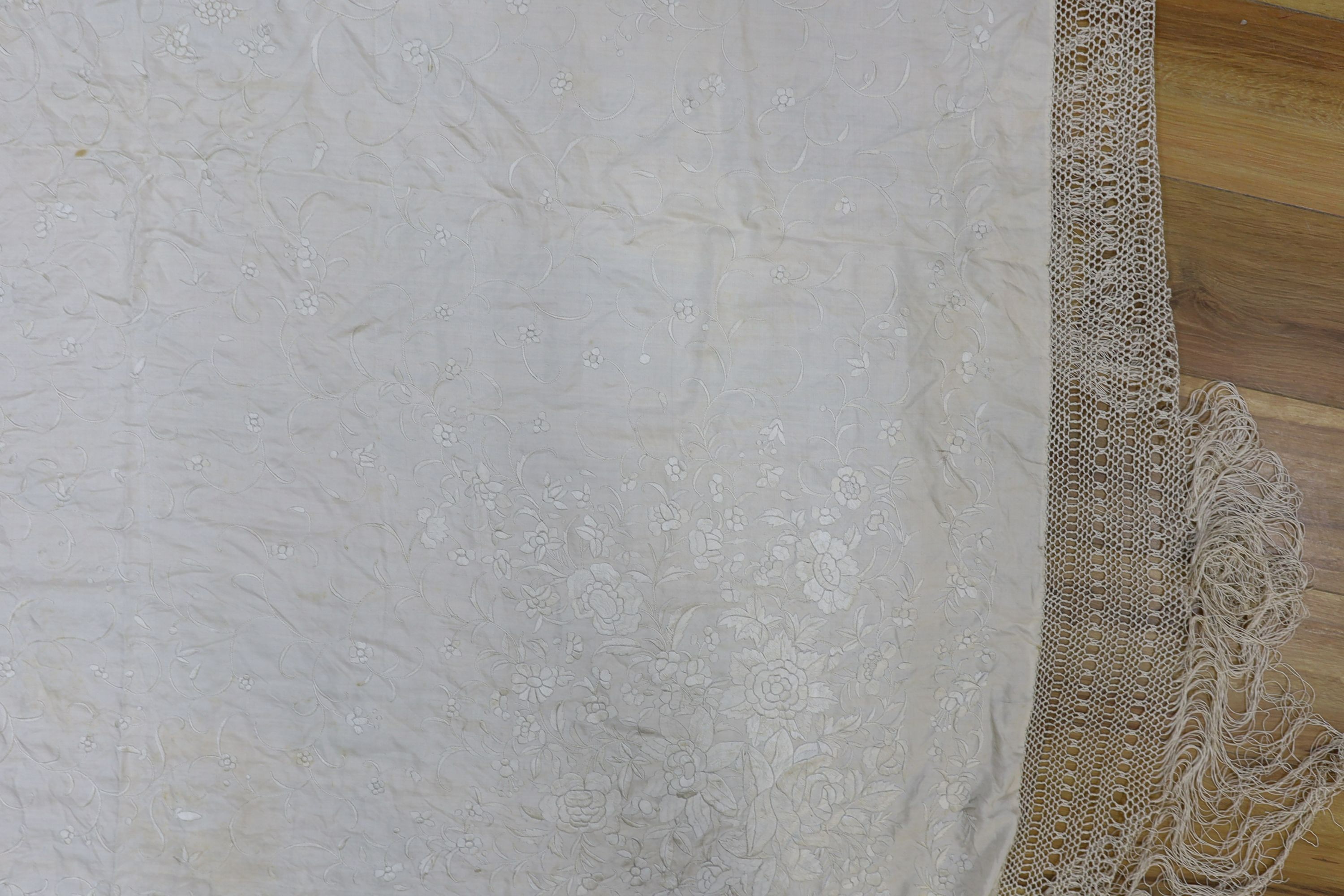 A 19th century cream embroidery on cream silk shawl together with a smaller later shawl